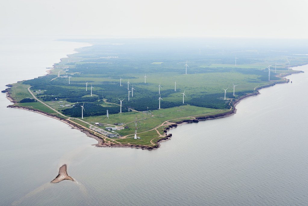 An aerial view wind turbines on the coast.